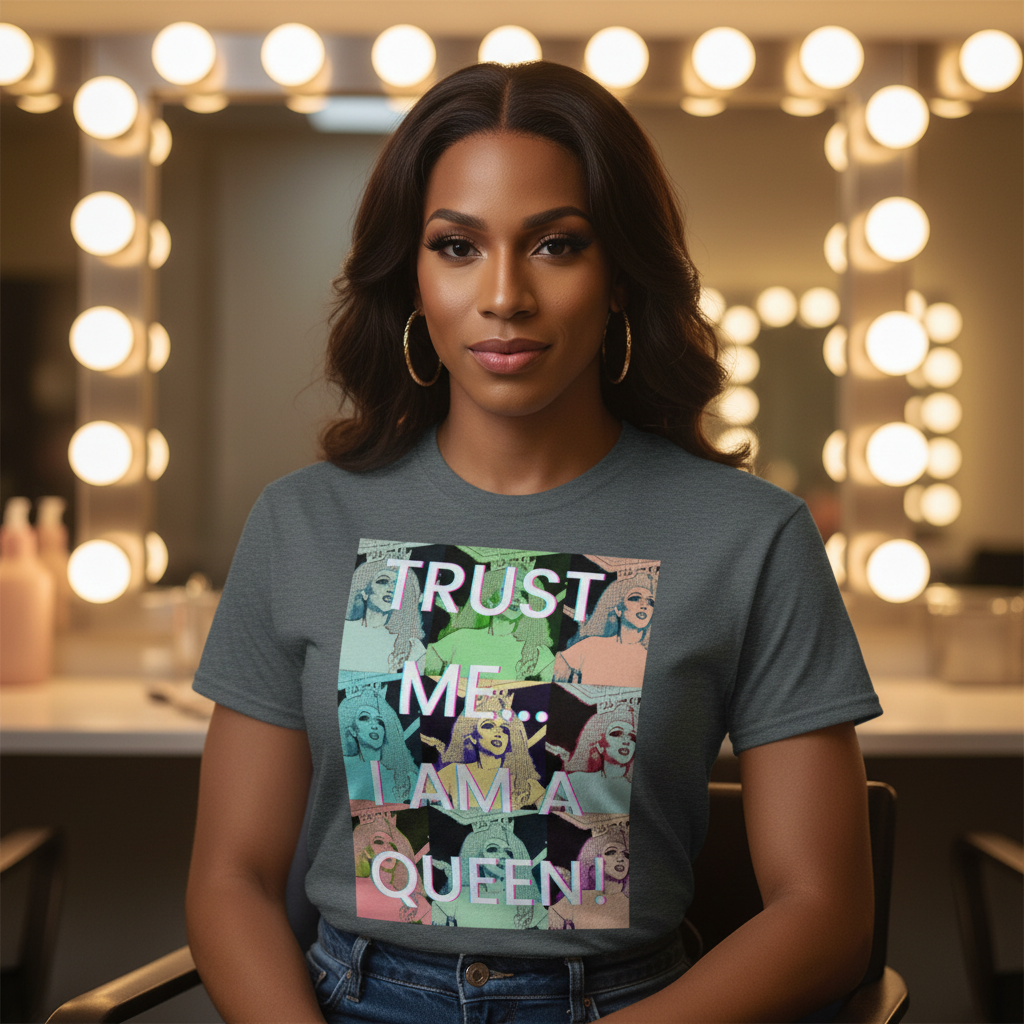 Trust Me...I Am A Queen!" T-shirt on a femme-presenting person with long brown hair, hoop earrings, in a bright makeup room.