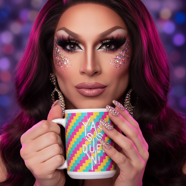 Drag performer with bold makeup and sparkly rhinestone nails holds the Yasss Queen Mug, featuring a geometric rainbow pattern, against a background of vibrant bokeh lights, embodying queer pride and vibrant self-expression.