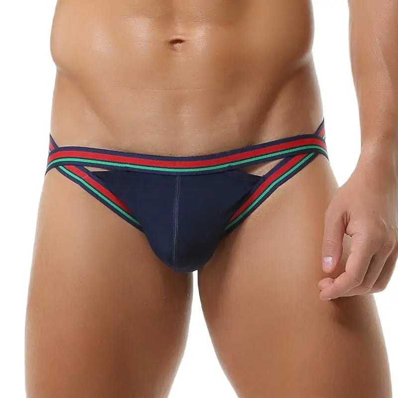 Model wearing a navy jockstrap with red and green striped trim