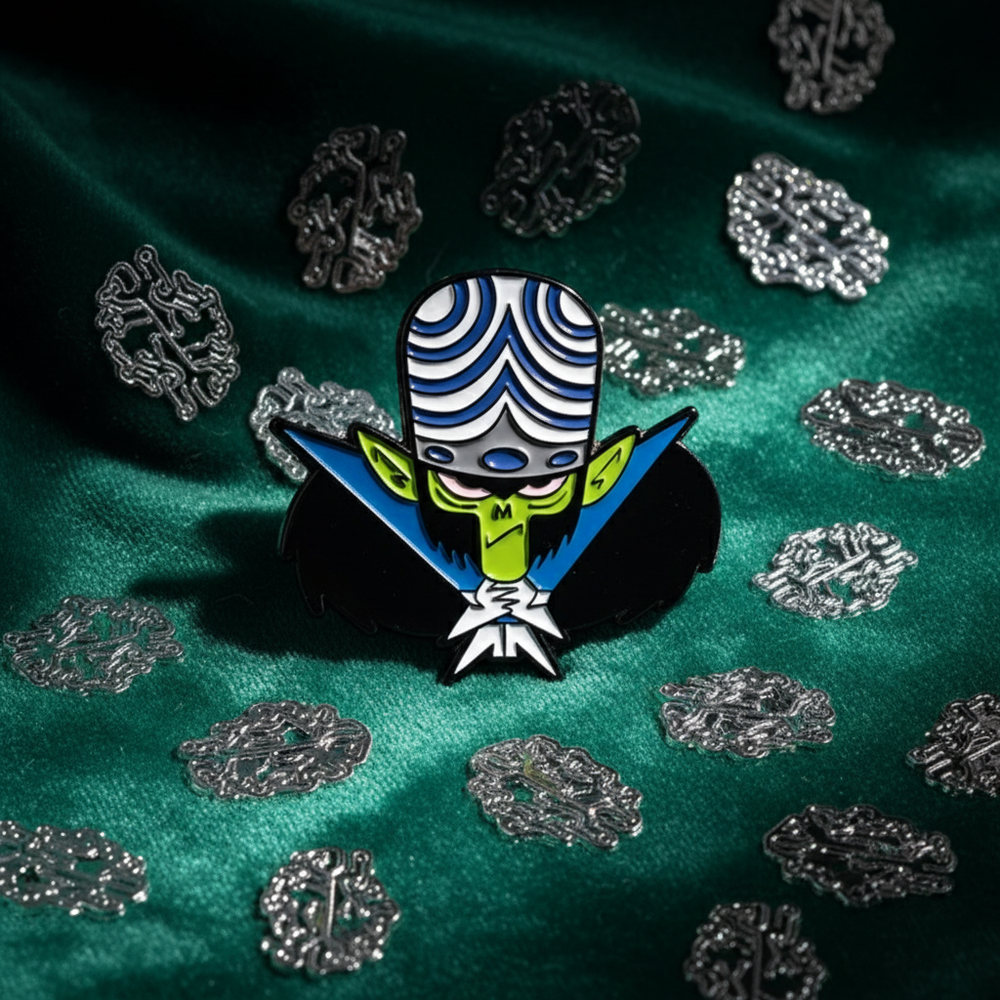 Enamel pin featuring Mojo Jojo in a blue-and-white striped hat on green fabric