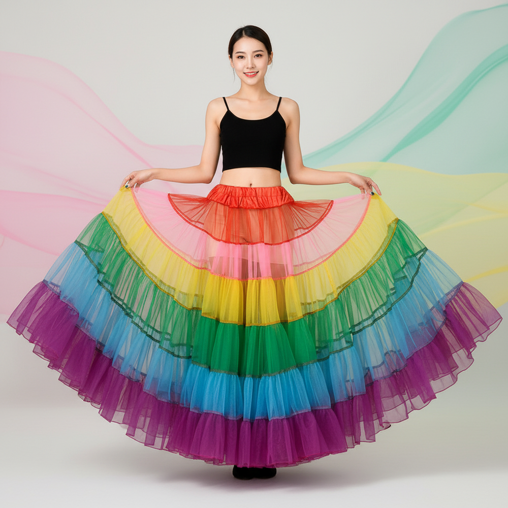 Front-facing model holds out a voluminous rainbow layered tulle tutu skirt
