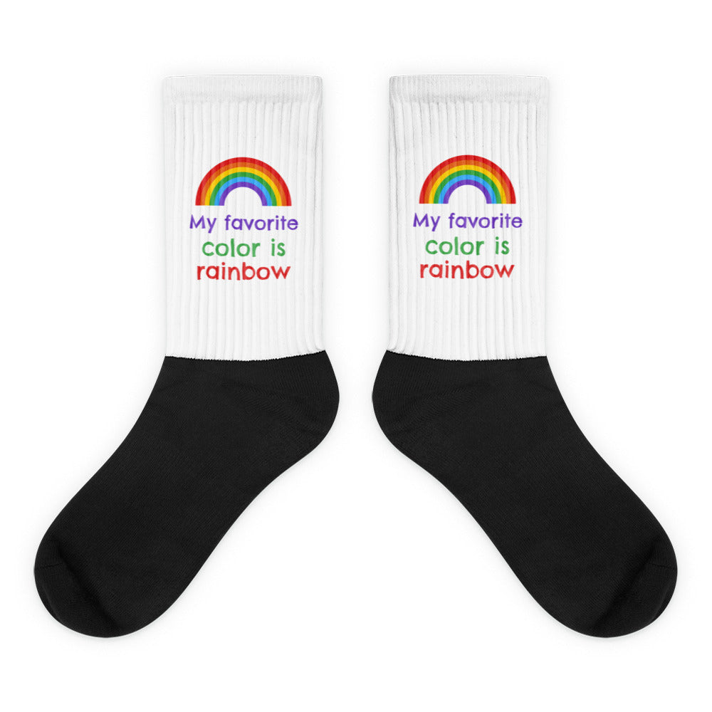 My Favourite Color Is Rainbow Socks feature a striking black foot and white leg with vibrant rainbow graphics