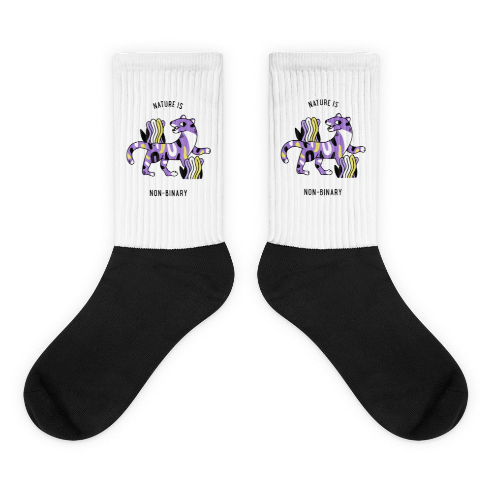 Pair of black-and-white socks with purple big-cat graphics and “NATURE IS NON-BINARY” text