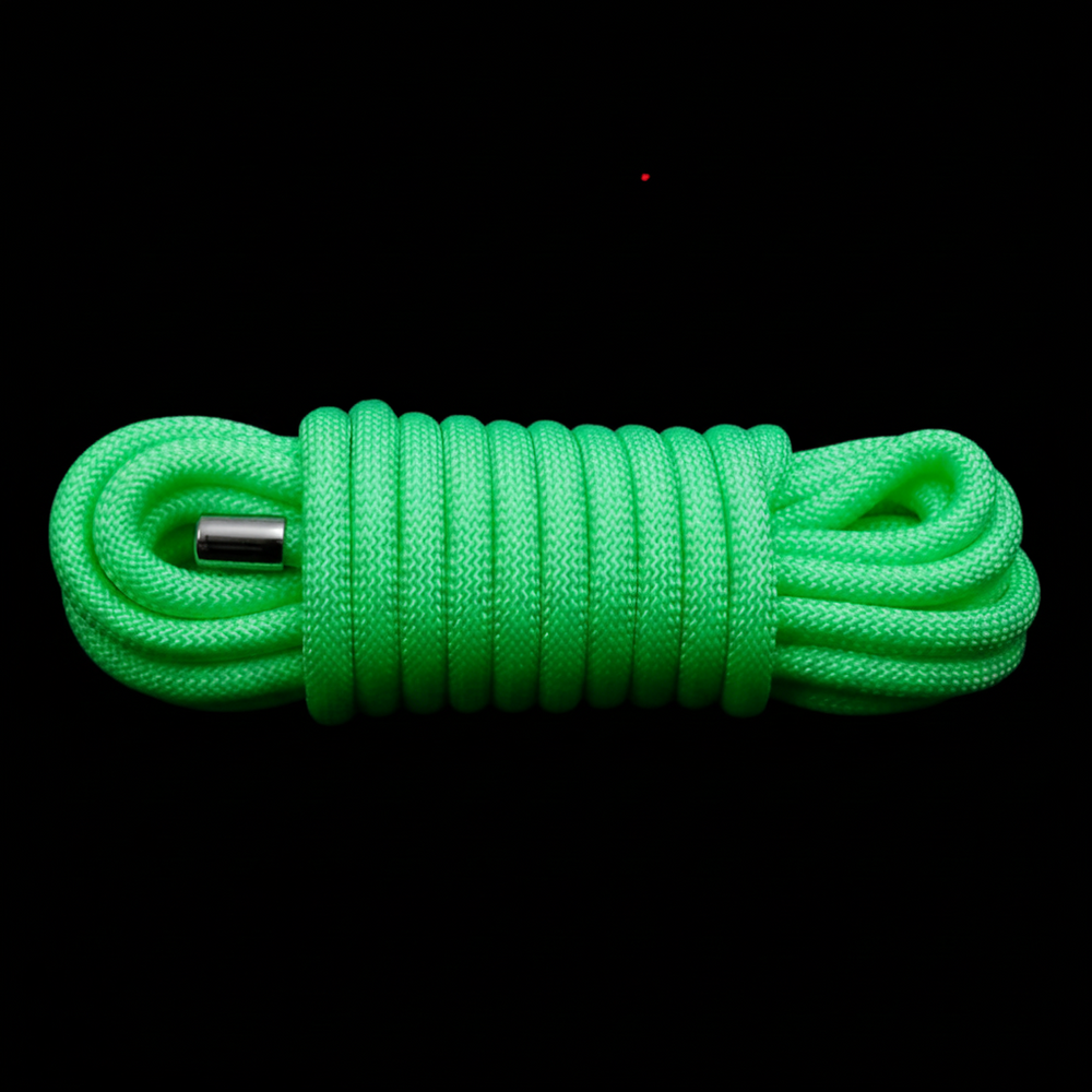 Neon green braided rope coiled around a central metal connector on black