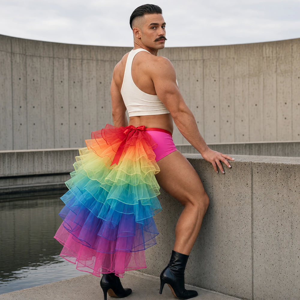 Model wearing a rainbow tulle rear bustle over pink dance shorts on a concrete terrace