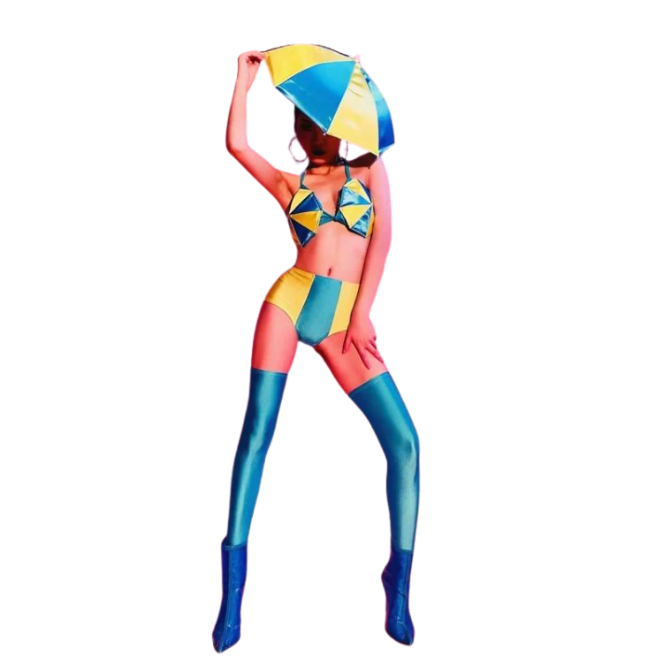Model in a yellow-and-teal bikini costume, thigh-high boots, and umbrella headdress