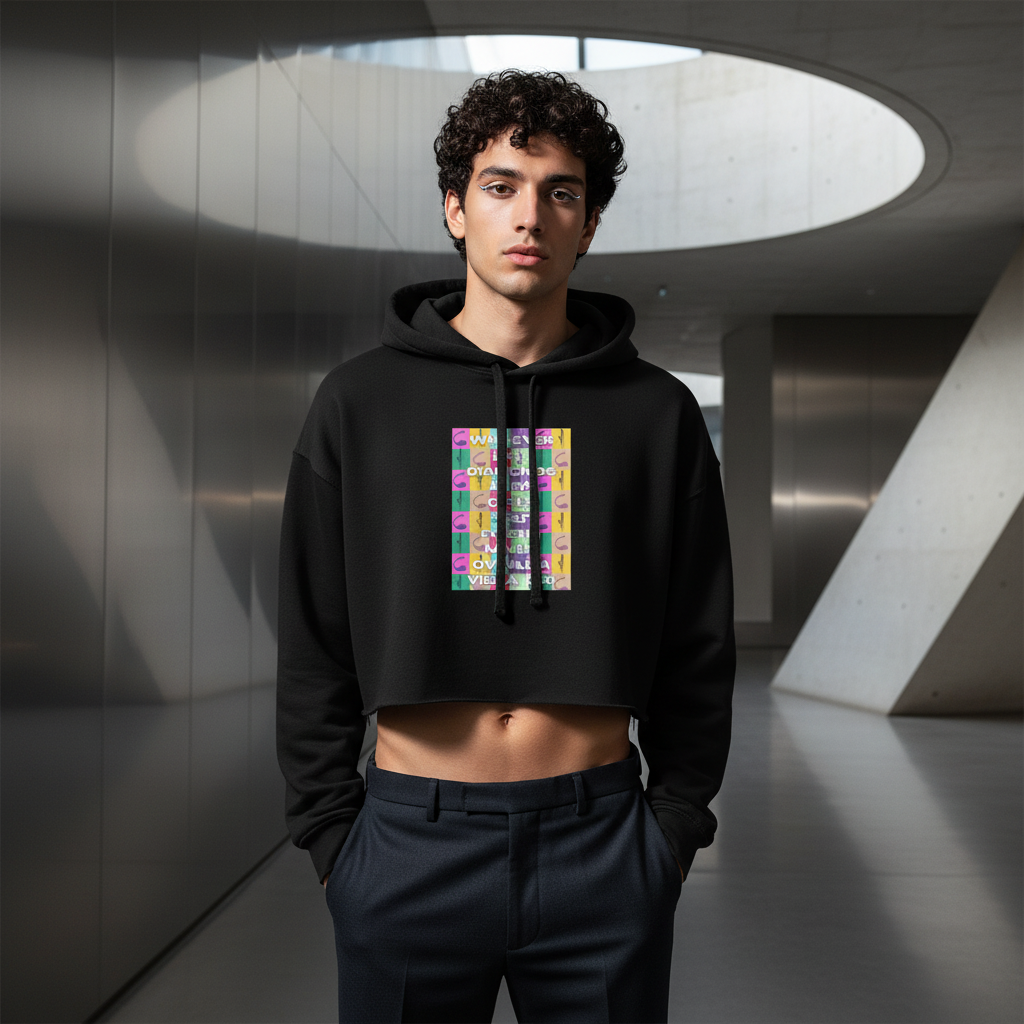Never Owned A Vibrator crop hoodie with bold, colorful graphics on a curly-haired guy; dark pants, modern space