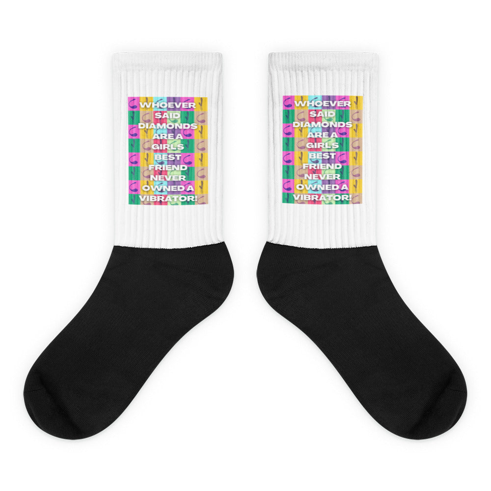 Pair of black-and-white socks with colorful cuffs reading “Whoever said diamonds are a girl's best friend never owned a vi...