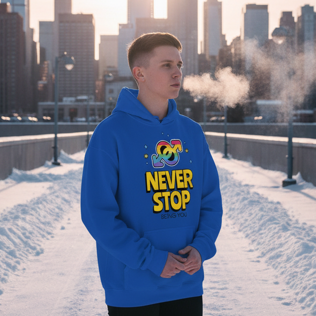 Person in a bright blue hoodie reading “NEVER STOP BEING YOU” on a snowy city bridge