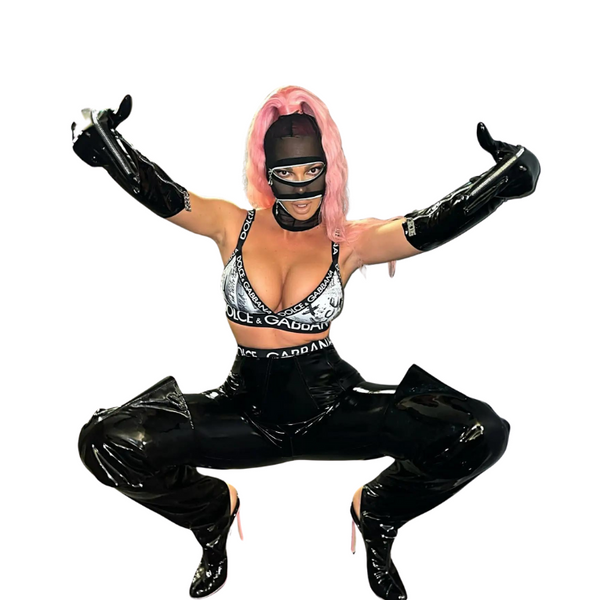 Masked model in glossy black thigh-high stiletto boots, crouching with arms raised