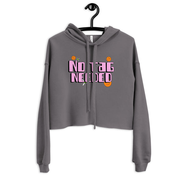 Front view of a charcoal cropped hoodie on a hanger with pink “NO TAG NEEDED” lettering