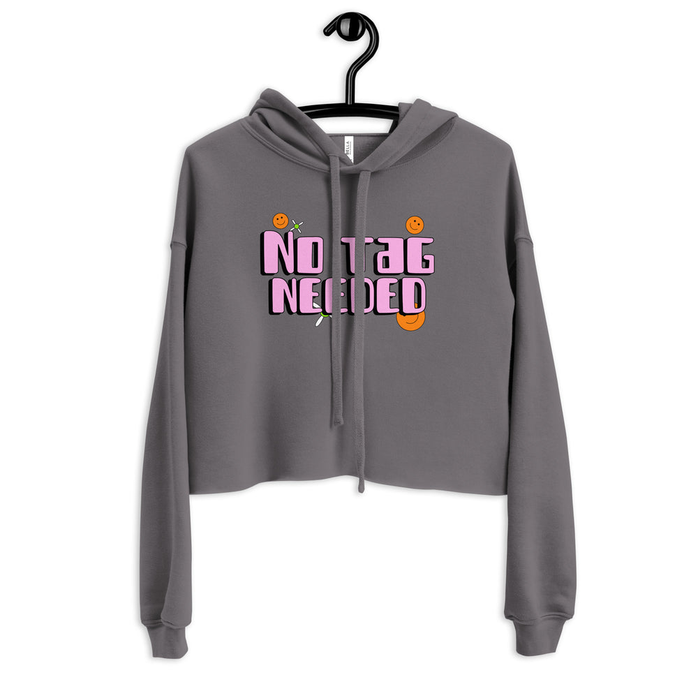 Front view of a charcoal cropped hoodie on a hanger with pink “NO TAG NEEDED” lettering