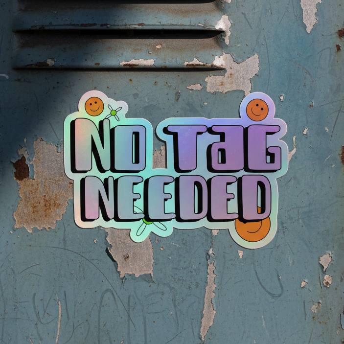 No Tag Needed holographic sticker with bold rounded lettering, cute smiling orange faces