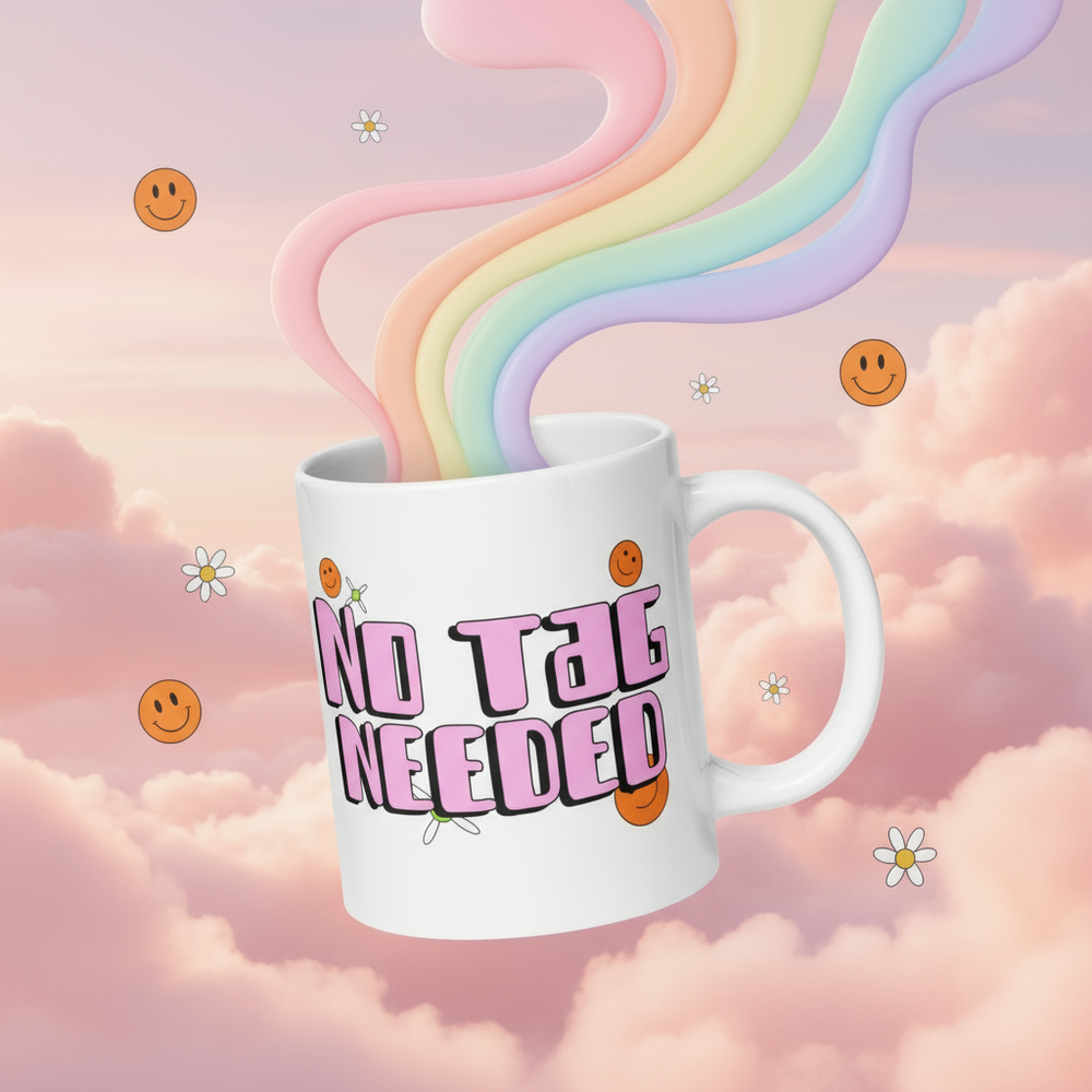 White mug reading “NO TAG NEEDED,” with smiley faces and daisies, releasing pastel rainbow streams