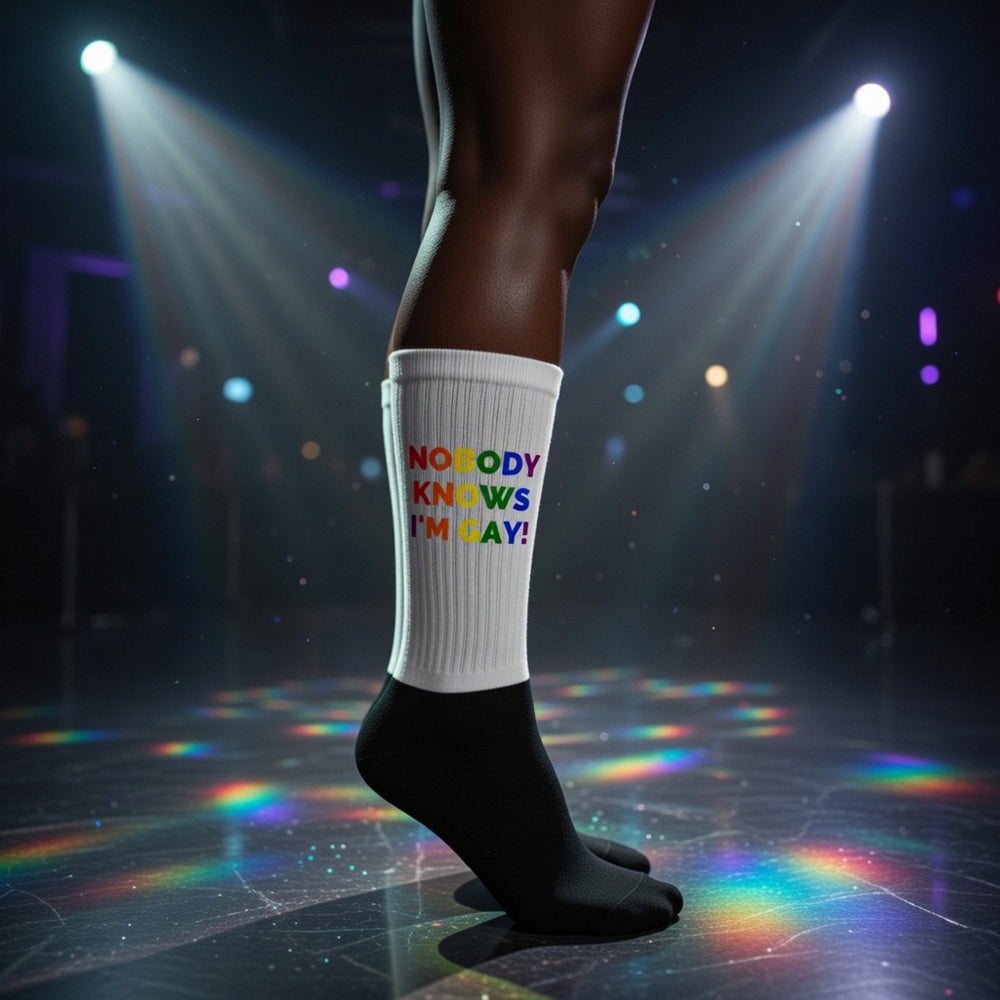 Nobody Knows Im Gay! socks with bold rainbow letters, rocked on stage in black shoes under colorful lights