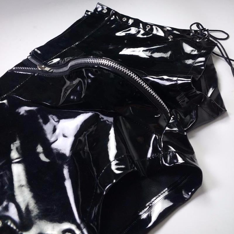 Close-up of black glossy vinyl lace-up boxers with multiple zippers