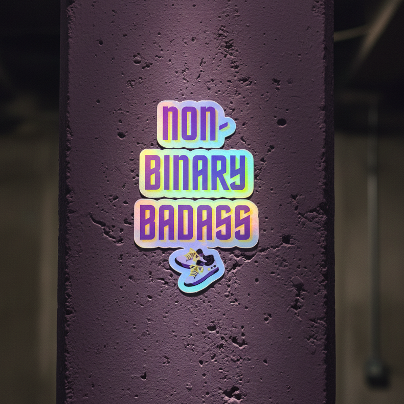 Holographic "Non-Binary Badass" sticker with retro bold font and shoe graphic shines on a dark purple textured pillar