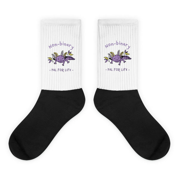 Pair of white and black socks with purple axolotls and “Non-binary Pal for Life” text