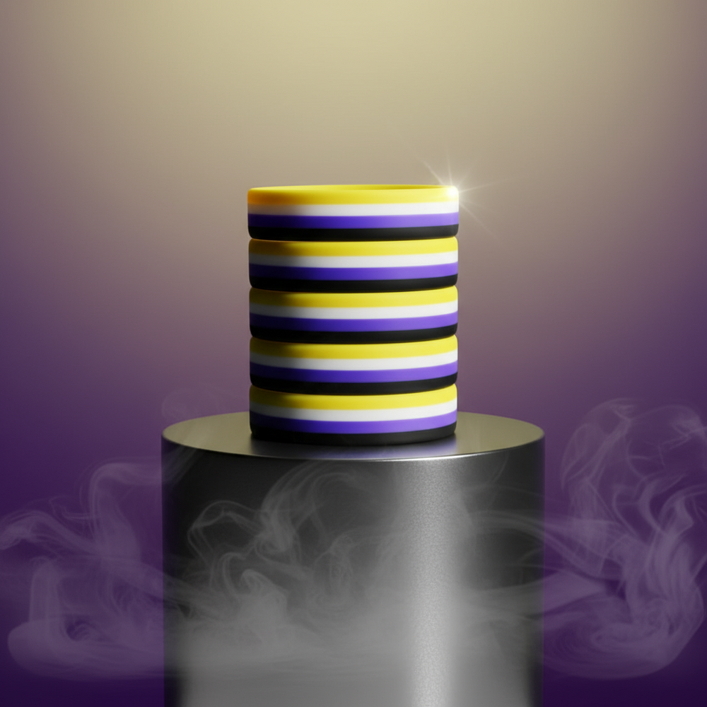 Five non-binary pride rubber wristbands stacked on a pedestal amid purple smoke