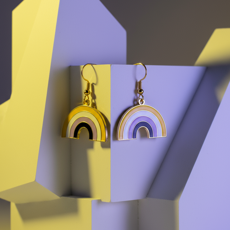 Pair of gold-tone rainbow arch drop earrings on a geometric yellow and lavender display