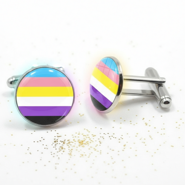 Pair of round nonbinary pride flag cufflinks on a white surface with gold specks