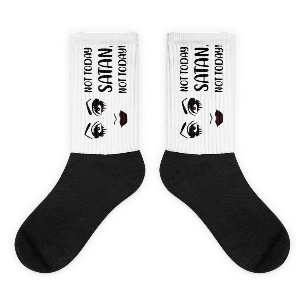 Pair of black-and-white crew socks reading “NOT TODAY SATAN!” with eye and lip graphics