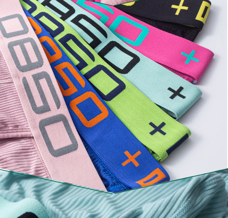Flat lay of colorful low-waisted briefs with geometric logo bands