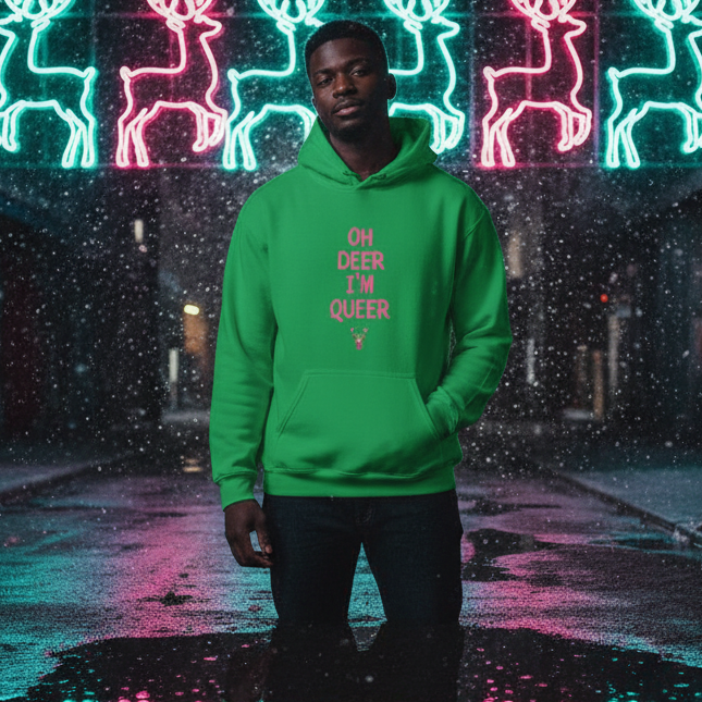 Model wearing a green hoodie reading “OH DEER I’M QUEER” in front of neon reindeer