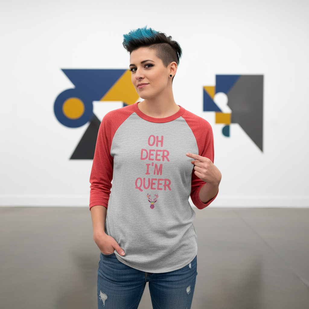 Gray and red 3/4 sleeve raglan shirt reads "Oh Deer I'm Queer," worn by a person with blue-black hair in an art gallery