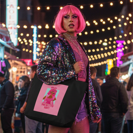 Large black tote bag with pink drag-queen graphic, carried by a person at a nighttime street market