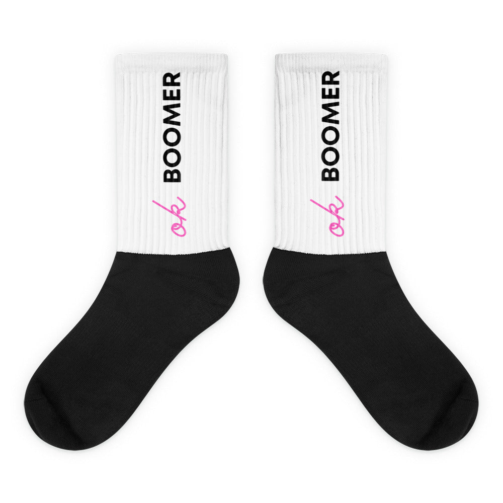Pair of black-and-white crew socks reading “ok BOOMER” in pink and black