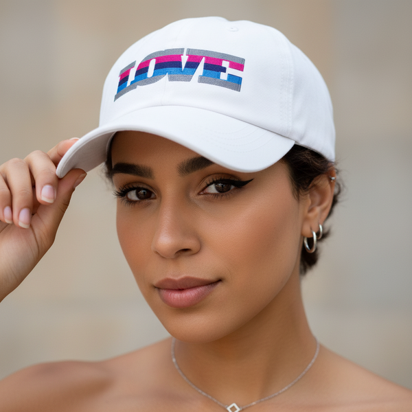 Omnisexual Love Cap in white, stitched with “LOVE” in rainbow stripes