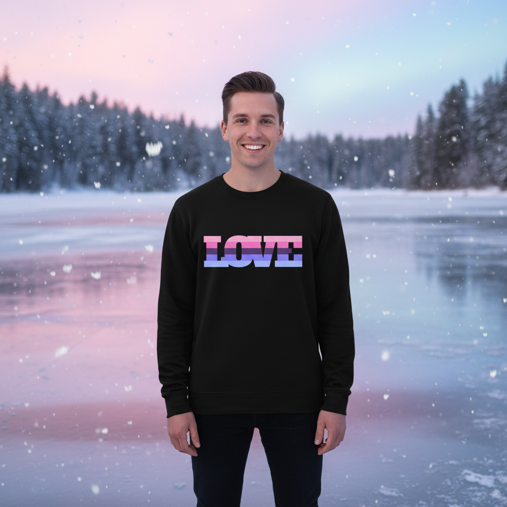 Smiling person in a black sweatshirt with pink-and-blue LOVE lettering, standing in falling snow