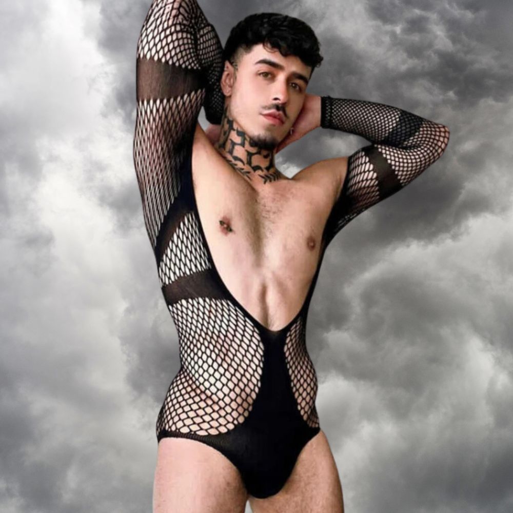 Model poses in a black fishnet bodysuit with sheer panels and solid cutout bands