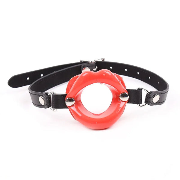Front-facing red open-mouth lip gag with a black adjustable leather strap
