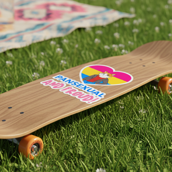 A skateboard with orange wheels on grass, repping a “Pansexual And Proud” sticker with a cartoon cat and pan flag heart
