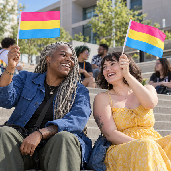 Adults celebrating with Pansexual Pride hand flags in the 20 x 30 cm size