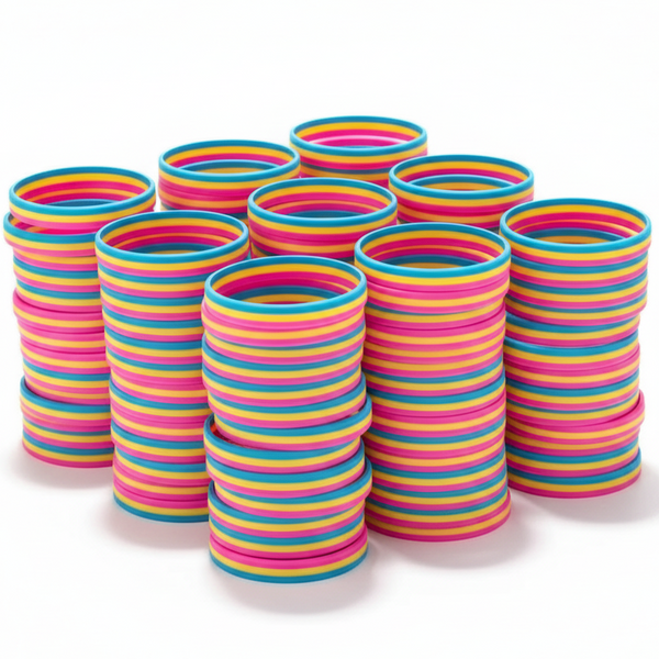 Stacks of multicolored striped silicone wristbands arranged on a white background