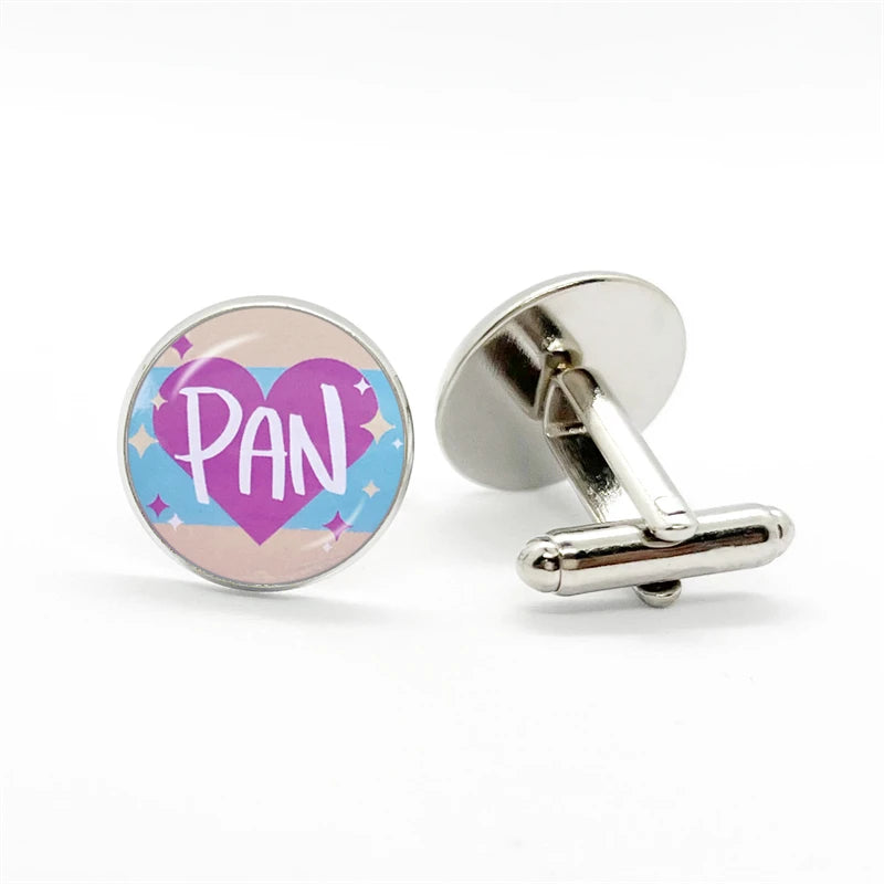 Pansexual pride cufflinks, one facing forward with a purple heart and “PAN,” one showing its T-bar back