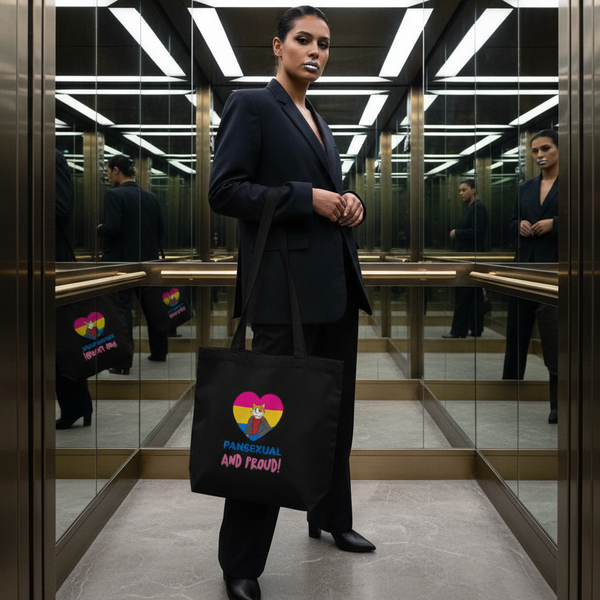 Person in a black suit holds a black tote reading “PANSEXUAL AND PROUD!” in a mirrored elevator