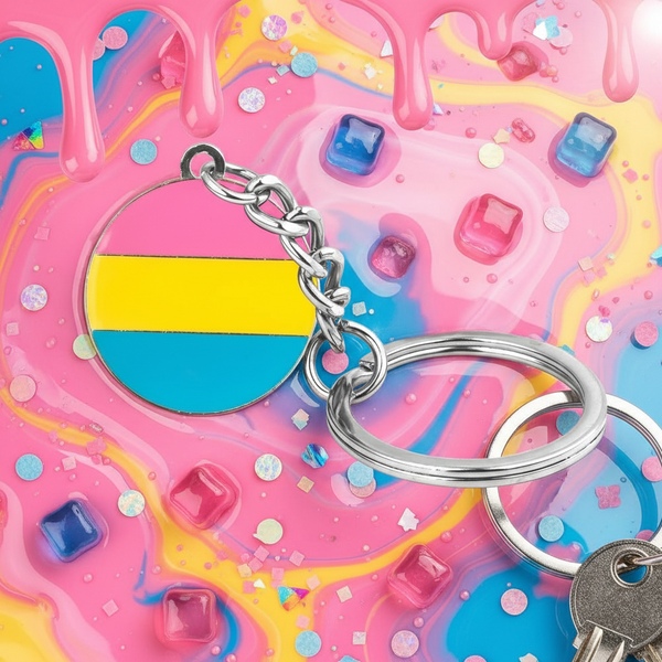 Pansexual pride circle keychain with pink, yellow, and blue stripes on a colorful candy-like background