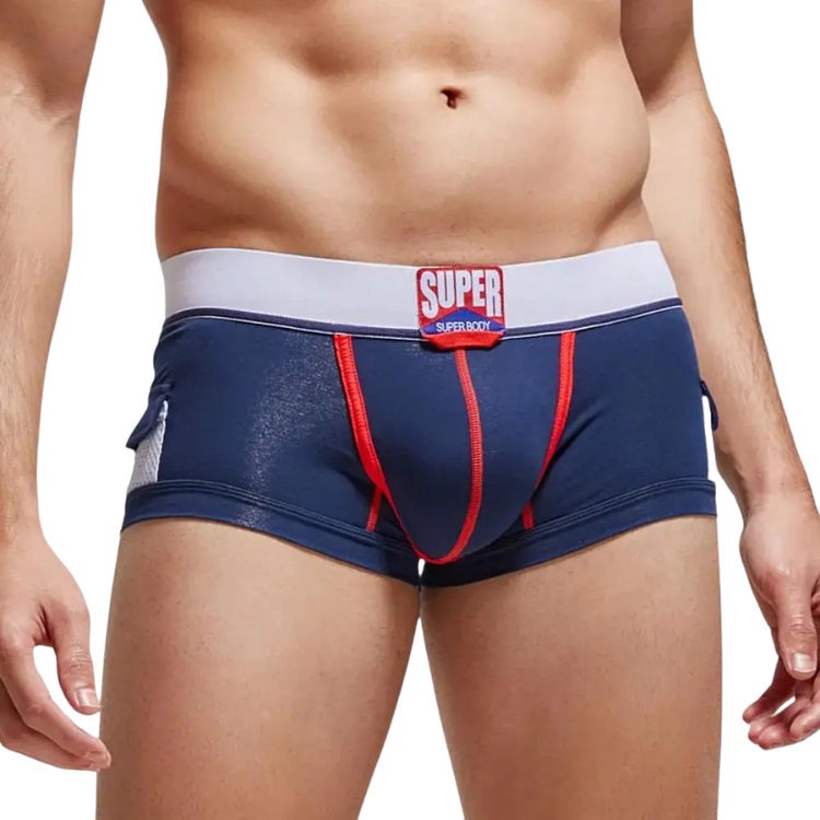Front view of a model wearing navy boxer briefs with red stitching and a white SUPER waistband