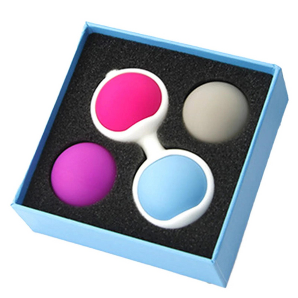 Open blue box holding four colored silicone Kegel balls in black foam