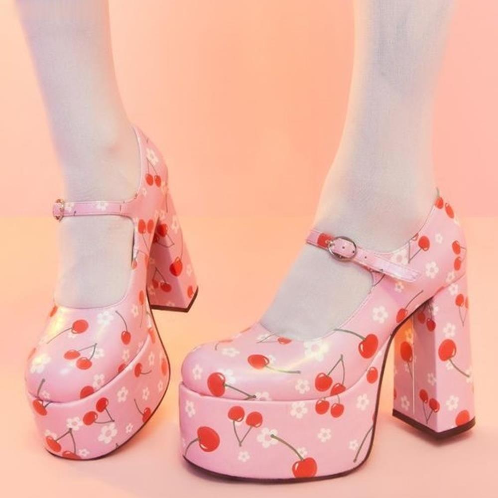 Pair of pink platform Mary Jane pumps with cherry and white flower print