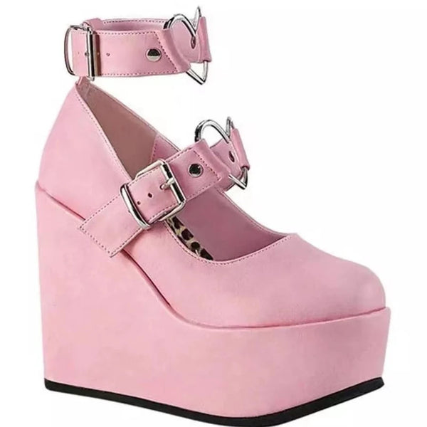 Pink platform wedge pump with two silver-buckled straps and a heart-shaped buckle detail