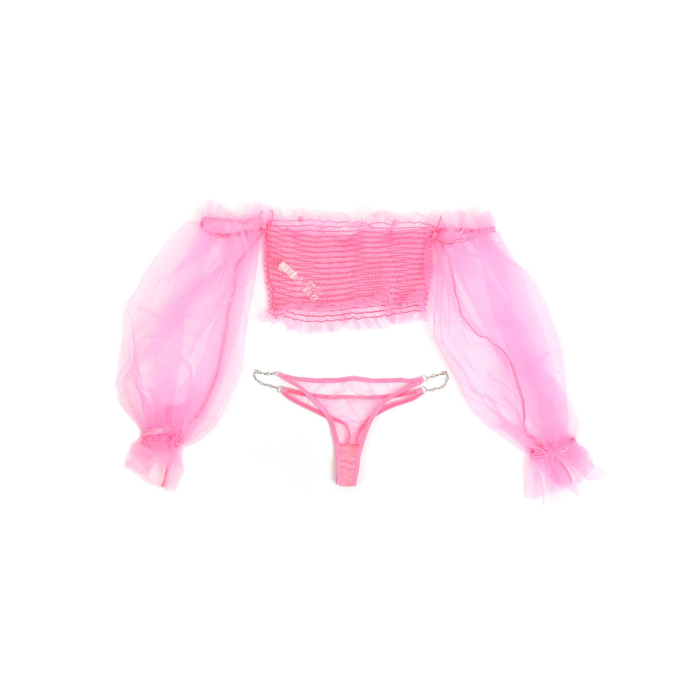 Flat lay of a pink sheer lingerie set with ruffled sleeves and a chain-strap thong
