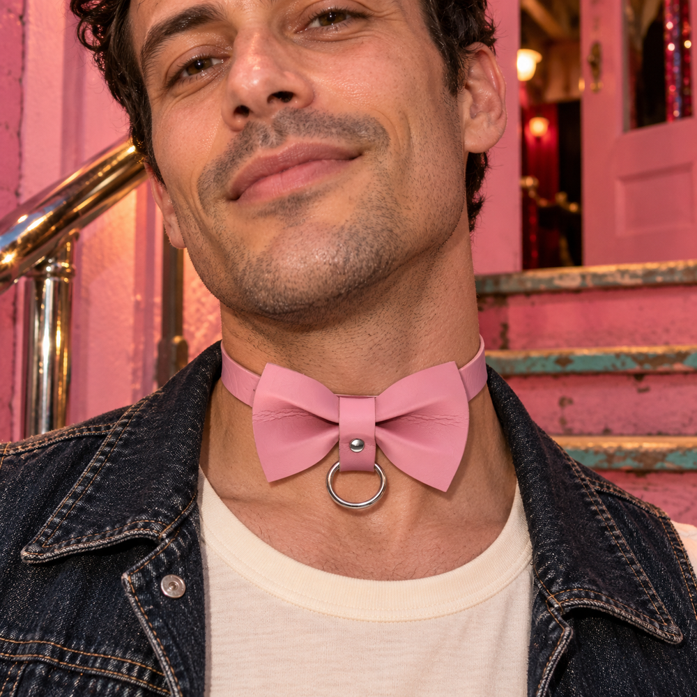 Femme Pink Punk Chokers in Bow, styled at a bubblegum-pink venue entrance with worn timber steps, a chrome handrail and soft evening light.