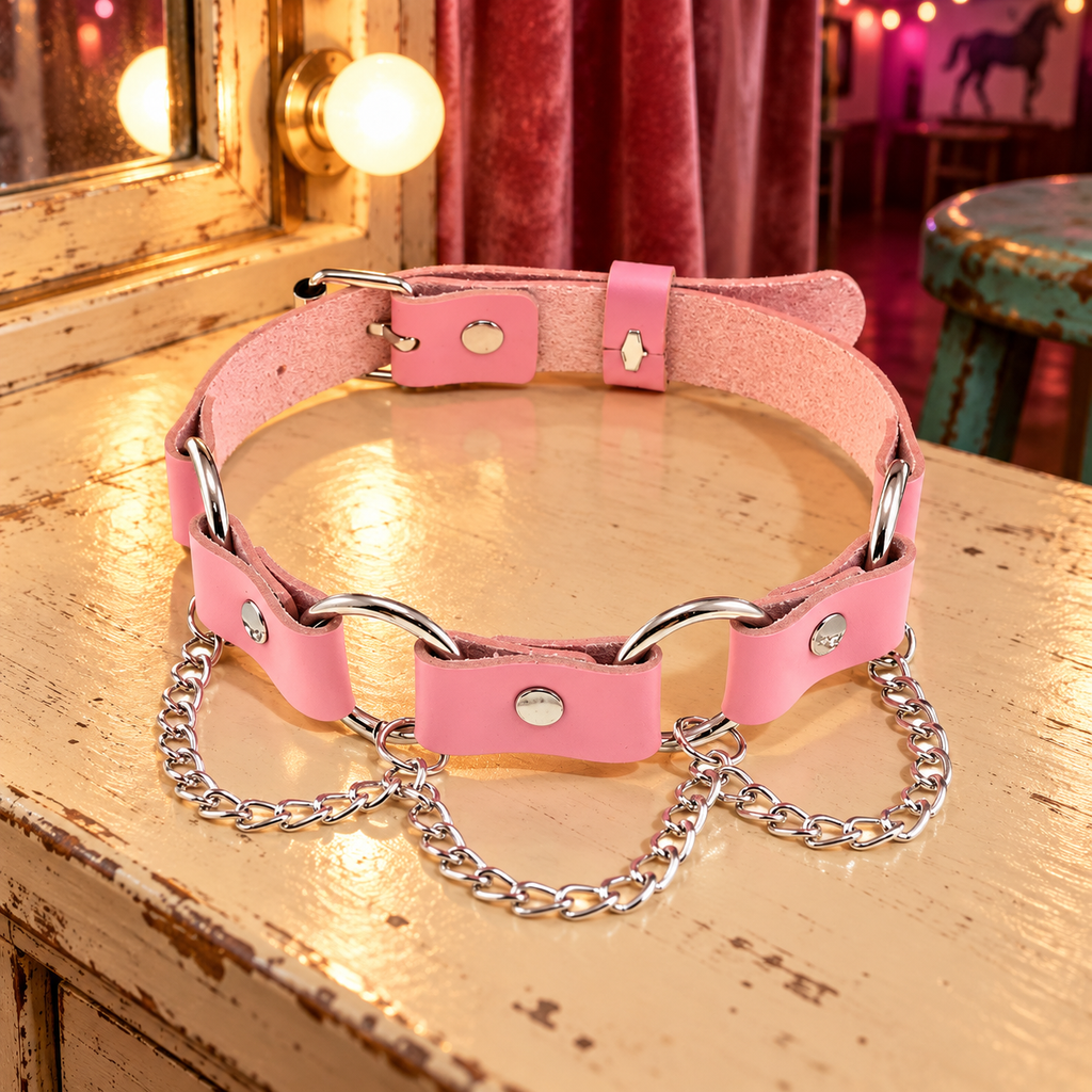 Femme Pink Punk Chokers in Hanging Chains, photographed on a cream dressing table in a pink Western dance hall.