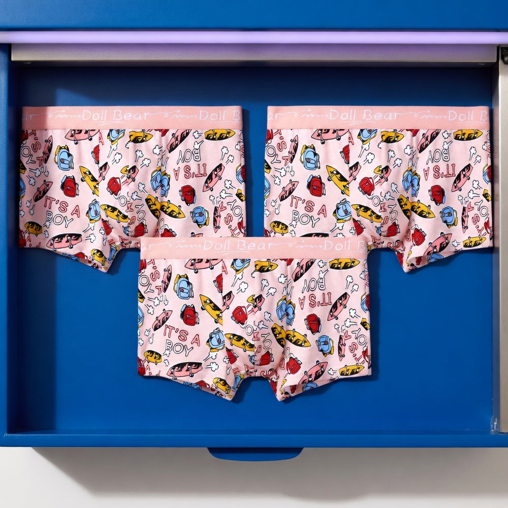 Three pairs of Pink Power boxer briefs in the Doodle print, displayed in a studio still life.