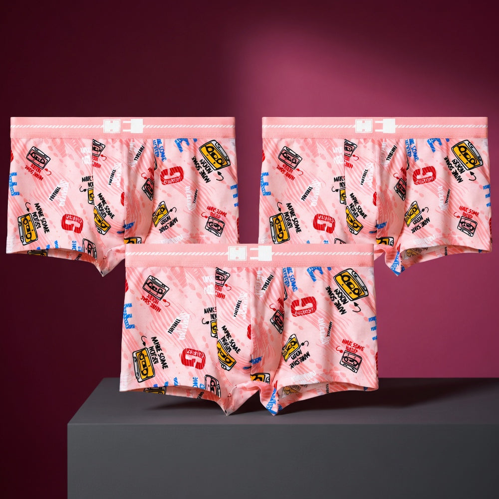 Three pairs of Pink Power boxer briefs in the Joyride print, displayed in a studio still life.
